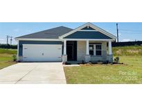 Charming new home features stone accents, a two-car garage and a well-manicured lawn at 444 Bent Burr Crk, York, SC 29745