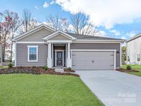 Charming one-story home with a well-manicured lawn and a two-car garage at 450 Bent Burr Crk, York, SC 29745