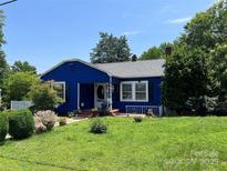 Charming blue single-story home with a well-manicured lawn and inviting front porch at 455 Wood Ave, Kannapolis, NC 28083