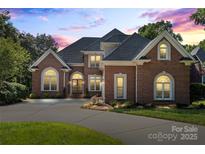 Beautiful brick home featuring manicured landscaping and an arched entryway at 4740 Myers Ln, Harrisburg, NC 28075