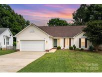Charming single Gathering home with a well-manicured lawn and two car garage at 5843 Timber Falls Nw Pl, Concord, NC 28027