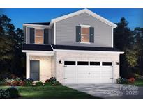Charming two-story home boasts a white brick facade, a two-car garage, and manicured landscaping at 750 Laguna Ave, York, SC 29745