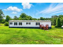 Well-maintained home with a cozy porch and lush green lawn at 1016 S D Ave, Maiden, NC 28650