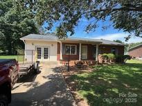 Single-story brick home with a well-maintained lawn and mature trees offering shade at 1616 Lazenby St # 17, Newton, NC 28658