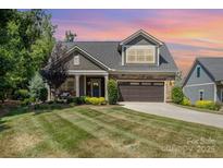Charming two-story home featuring a well-manicured lawn, stone accents, and an attached two-car garage at 2245 Lincolnshire Ln, Waxhaw, NC 28173