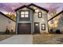 Charming two-story home featuring a modern exterior, garage and inviting front door at 2813 Ava Ave, Charlotte, NC 28208