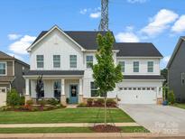 Beautiful two-story white home featuring a manicured lawn and a welcoming blue front door at 301 Supernova Dr, York, SC 29745
