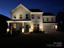 Beautiful two-story home featuring meticulous landscaping and charming curb appeal at twilight at 301 Supernova Dr, York, SC 29745