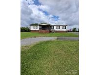Charming home featuring a covered front porch, mature lawn, and gravel driveway at 315 S Grandview Rd, Clover, SC 29710
