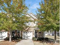 Charming two-story townhouse with brick and siding, a one-car garage, and well-maintained landscaping at 3230 Yarmouth Ln, Gastonia, NC 28056