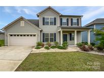 Charming two-story home with a well-manicured lawn, attached two-car garage, and inviting front porch at 3486 Duchess Ave, Fort Mill, SC 29707