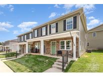 Charming townhouse featuring stone accents, a welcoming front porch, and well-manicured lawn at 3965 Hemingway Dr, Hickory, NC 28601