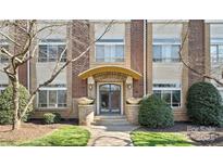 Elegant brick building entrance with an arched doorway and manicured landscaping at 404 N Laurel Ave # 11, Charlotte, NC 28204
