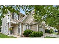 Charming home with tan siding, green bushes, and a well-maintained front yard at 424 Paperbark Ln, Rock Hill, SC 29732
