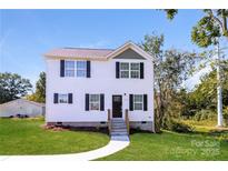 Charming two-story home with a well-manicured lawn, new walkway, and inviting front entrance at 515 Kings Mountain St, Clover, SC 29710