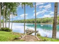 Scenic lake view with a private dock, steps, and lush landscaping, creating a tranquil waterfront retreat at 6719 Love Point Rd, Denver, NC 28037