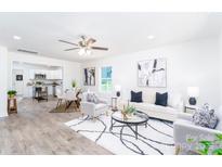 Bright open-concept living room with sleek decor and an adjoining kitchen and dining area at 810 W Raleigh Ave, Statesville, NC 28677