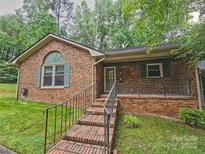 Charming brick home with a welcoming front porch and well-maintained landscaping at 109 Phil Ct, Fort Mill, SC 29715