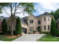 Beautiful two-story brick home with a well-manicured lawn and a two car garage at 11841 Churchfield Ln, Charlotte, NC 28277