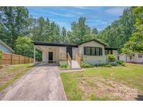 Charming single-story home with covered parking, a well-maintained lawn, and inviting front entrance at 1214 Northwoods Dr, Kings Mountain, NC 28086