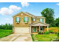 Charming two-story brick home with green shutters and a well-manicured lawn at 124 Vintage Woods Ct, Shelby, NC 28150