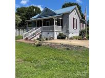 Charming home with a light blue metal roof, vinyl siding and a welcoming front porch at 15 Rose St, York, SC 29745