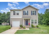 Charming two-story home featuring a well-maintained front yard and a classic design with a single car garage at 152 Grassy Meadow Ln, Statesville, NC 28625