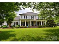 Charming two-story home with inviting front porch and manicured lawn at 19625 Callaway Hills Ln, Davidson, NC 28036