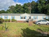 Charming single-story home with light siding, blue shutters, and a well-maintained front yard at 2194 Sterling Ridge Dr, Newton, NC 28658