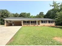 Charming ranch-style home with a covered carport and well-maintained lawn at 279 Bailey Rd, Lancaster, SC 29720