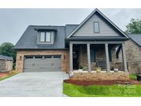 Charming single-Gathering home featuring a covered front porch and two car garage at 29 Shanklin Ln, Denver, NC 28037