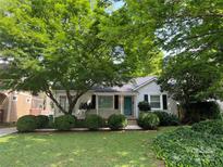 Charming one-story home with lush landscaping, mature trees, and a welcoming front yard at 3339 Benard Ave, Charlotte, NC 28206