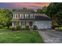 Charming two-story home featuring a landscaped front yard and a two-car garage at 3505 Mallard Cove Ct, Charlotte, NC 28269