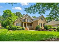 Charming brick home with a manicured lawn, mature trees, and inviting front porch at 3735 Gordon St, Terrell, NC 28682
