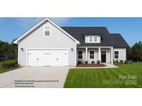 Charming one-story home featuring a two-car garage, covered front porch, and well-manicured lawn at 4018 Deerstone Ln # 24, Clover, SC 29710