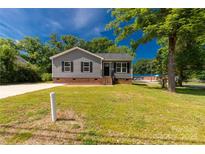 Charming single-Gathering home with manicured lawn and traditional design elements at 506 Locust St, Rock Hill, SC 29730