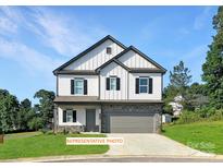 Charming two-story home featuring white siding, a stone foundation, and a two-car garage for modern Gathering living at 530 Hullview Vis, Monroe, NC 28110