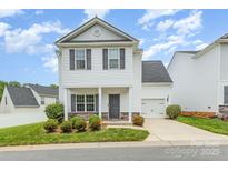 Charming two-story home with white siding, gray shutters, landscaped yard, and attached garage, in a sunny neighborhood at 8005 Stevie Oaks Ln, Charlotte, NC 28215
