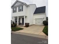 Charming two-story home with a garage, neat landscaping and a well-maintained lawn at 8005 Stevie Oaks Ln, Charlotte, NC 28215