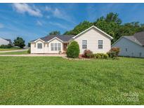 Charming one-story home with a well-manicured lawn and inviting curb appeal on a sunny day at 1271 Applewood Ln, York, SC 29745