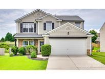 Charming two-story home with a well-manicured lawn, two car garage, and classic curb appeal at 1583 Cold Creek Pl, Huntersville, NC 28078