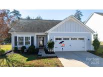 Charming single-story home with a well-maintained lawn and a delightful snowman decal on the garage door at 16142 Commodore Dr, Lancaster, SC 29720