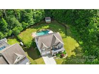 Beautiful aerial view of home and backyard featuring a lovely pool and shed at 1970 Topaz Plz, Davidson, NC 28036