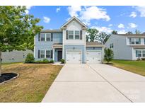 Charming two-story home with a two-car garage, nicely landscaped yard, and inviting curb appeal at 3107 Riker St, Clover, SC 29710