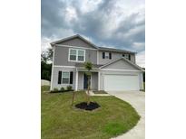 Two-story home featuring gray siding, a two-car garage, and a well-manicured lawn at 323 J C Dellinger Rd, Cherryville, NC 28021