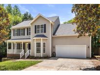 Charming two-story home with a two-car garage and a well-maintained lawn at 3429 Lazy Day Ln, Charlotte, NC 28269