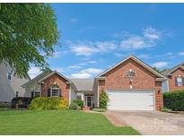 Charming brick home featuring a well-manicured lawn and a two-car garage at 4797 Chesney Nw St, Concord, NC 28027