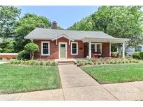 Charming brick home with covered porch, manicured lawn, and inviting curb appeal at 536 Carroll St, Statesville, NC 28625