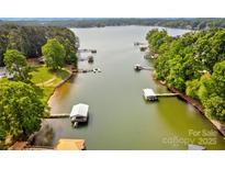 Breathtaking aerial view showcasing the lake and boat docks, with lush green trees and clear water at 669 Kenway Loop, Mooresville, NC 28117