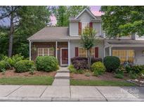 Charming two-story home featuring a well-maintained lawn with lush landscaping and a welcoming front entrance at 7121 Bidford Ct, Indian Land, SC 29707